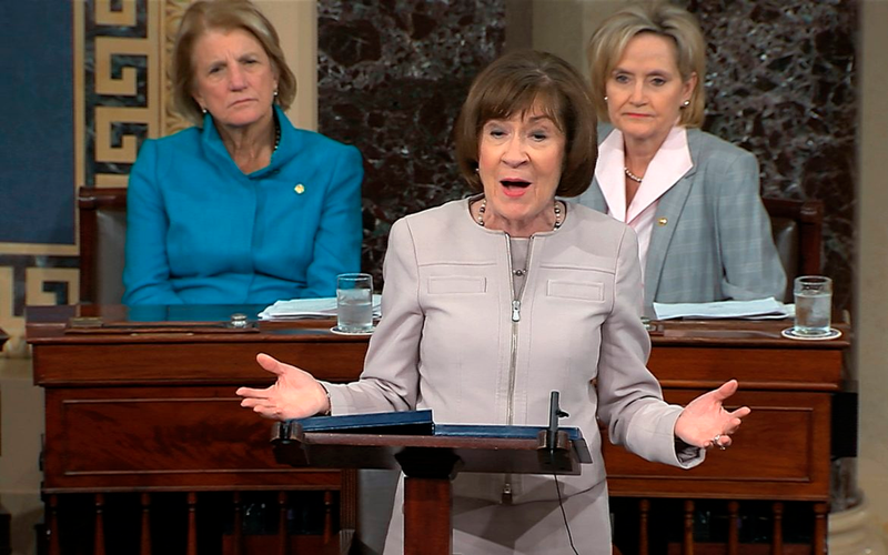 Sen. Cindy Hyde-Smith sits to the right.